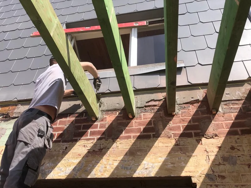 vakman plaatst dakbalken van het plat dak